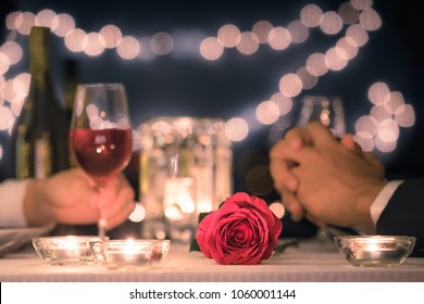 Romantic Dinner Date Night. Focus On Red Rose.