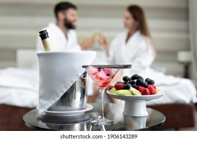 Romantic dinner in the hotel of berries and fruits for a young couple who drinks champagne in bed. - Powered by Shutterstock