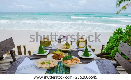 Romantic dinner on the beach in Koh Kood Thailand, dinner table with Asian food with fish and crab and lobster