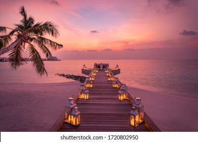 Romantic Dinner On The Beach With Sunset, Candles With Palm Leaves And Sunset Sky And Sea. Amazing View, Honeymoon Or Anniversary Dinner Landscape. Exotic Island Evening Horizon, Romance For A Couple 