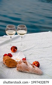 Romantic Dinner On The Beach With Wine And Cheese, Summer Picnic On The Beach. Glasses Of White Wine, Camamber Cheese, Fruits, Picnic Theme