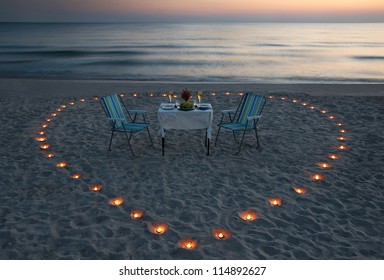 Romantic Dinner On The Sea Beach With Candle Heart In Maldives