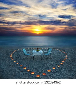 Romantic Dinner On Sea Beach With Candle Heart On The Sand