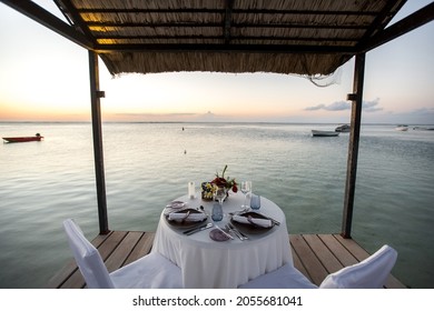 Romantic Dinner Setting On The Beach At Sunset