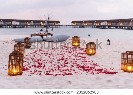 Romantic dinner setup by the beach with a beautiful ocean view in the background