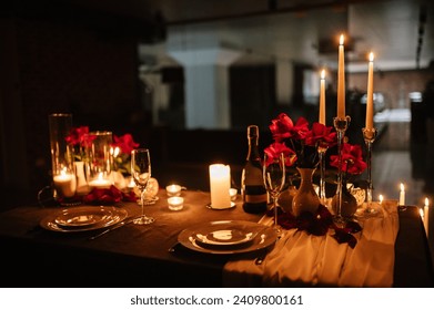 Romantic dinner setup at night. Champagne glasses, flowers. Table setting for a couple, Valentine's Day evening, burning candles for a surprise marriage proposal. Candle light date in a restaurant. - Powered by Shutterstock