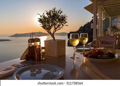 Romantic Dinner For Two On The Island Santorini, Greece. Views Of The Sea And The Volcano