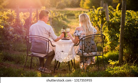 Romantic dinner with wine tasting in a place at sunset - Powered by Shutterstock