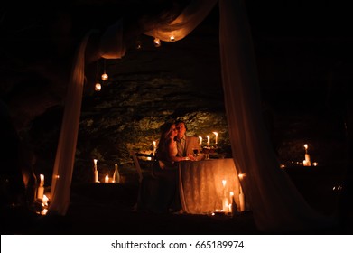 Romantic dinner of a young couple by candlelight in the mountains
