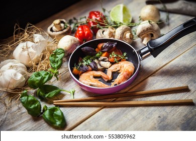 Romantic dish: prawns with colorful bell peppers, vegetables, basil, tomatoes in pan with sauce in St Valentines day - Powered by Shutterstock