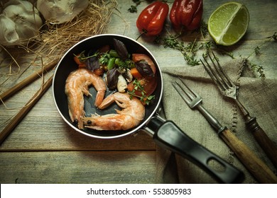 Romantic dish: prawns with colorful bell peppers, vegetables, basil, tomatoes in pan with sauce in St Valentines day - Powered by Shutterstock