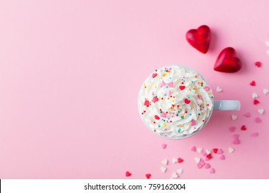 Romantic drink, coffee, latte, cappuccino with whipped cream. Top view. Pink background.