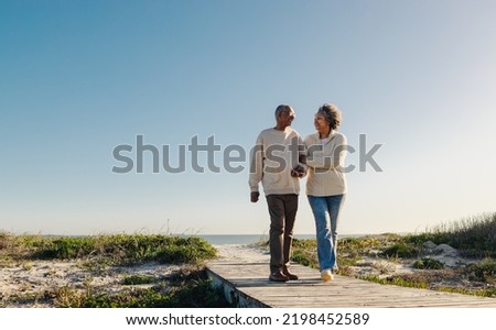 Similar – Image, Stock Photo Old smiling retired woman doing a live streaming near the sea, answering followers and saying hello.