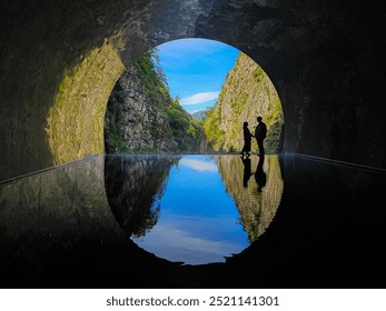 Romantic Escape: Couple's Reflection in Kiyotsu Tunnel on Sunny Day, Niigata, Japan. - Powered by Shutterstock