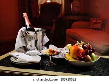 Romantic Evening With Bottle Of Champagne, Sweets And Fruits In The Hotel Room