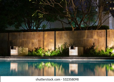 Romantic Evening Mood Lighting Casting Shadows Onto A Romantic Setting Near The Pool.  This Luxury Home Has Some Of The Best Landscaped Gardens And Tropical Flora In The World.