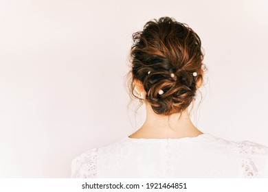Romantic formal hairstyle on brown hair, back view