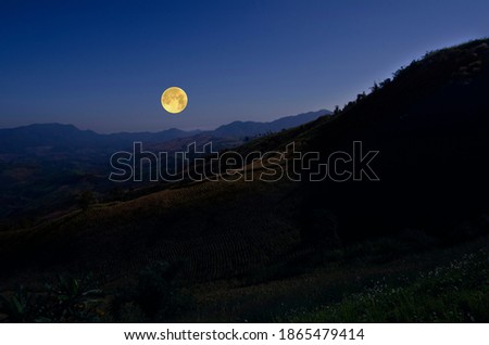 Romantic full moon over the mountains in the evening