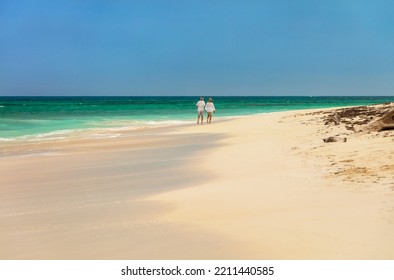 Romantic Getaway At Tropical Island Resort For Healthy Retired Caucasian Couple Walking Together By Turquoise Ocean Bahamas