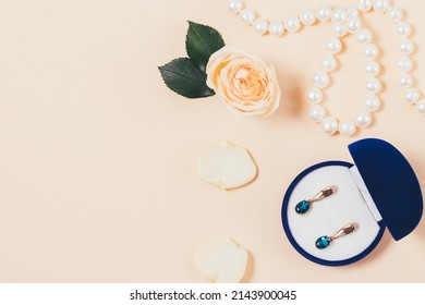 Romantic Gifts Jewelry Earrings In Box And Pearl Necklace, Flat Lay Composition On Beige Background With Copy Space