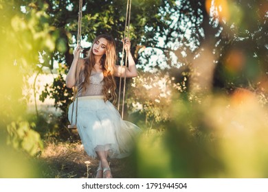 Romantic Girl With Long Hair Swinging On Rope Swing On Summer Nature, Young Woman Relaxing, Leisure Activity, Lifestyle Concept