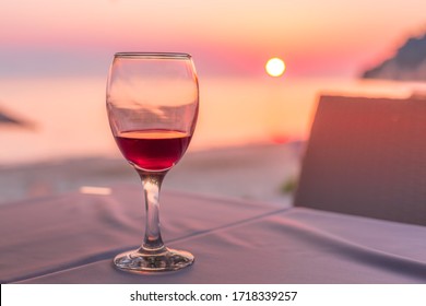 Romantic Glass Of Wine. Sunset On Beach Reflected In Red Wine, Summertime Vacation Concept