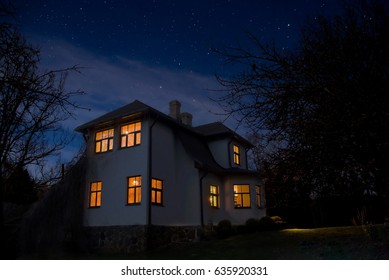 Romantic House With A Light In The Window. Night Landscape.