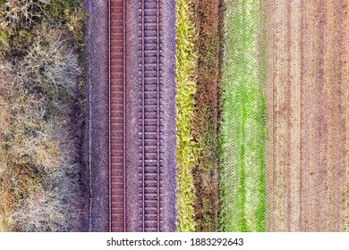 Romantic image of two railway tracks which consists of two parallel steel rails, anchored perpendicular to members called ties (sleepers) of concrete to maintain a consistent distance apart. Copyspace