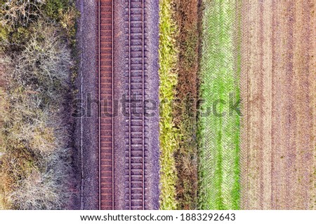 Romantic image of two railway tracks which consists of two parallel steel rails, anchored perpendicular to members called ties (sleepers) of concrete to maintain a consistent distance apart. Copyspace