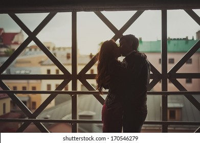 Romantic kiss of two lovers in the city / Young happy couple