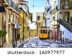 Romantic Lisbon street with the typical yellow tram and Lisbon Cathedral on the background 