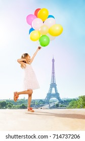 Romantic little girl with bright balloons in Paris