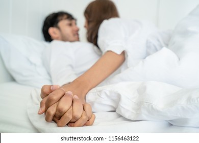 Romantic love of intimate young couple in home bedroom foreplay in the bed.