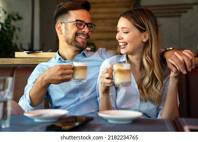 Romantic loving couple drinking coffee, having a date in the cafe. - Powered by Shutterstock