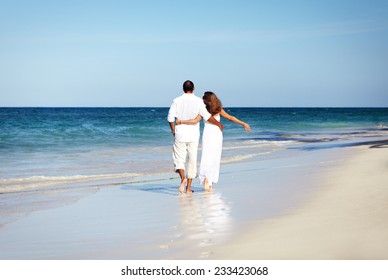 Romantic loving couple walking on the beach. Caribbean vacation.       - Powered by Shutterstock