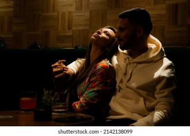 Romantic Low Light. Amazing Couple Is Sitting Under The Lights