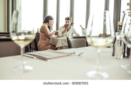 romantic lunch in a fancy restaurant.couple sitting and eating at lunch time