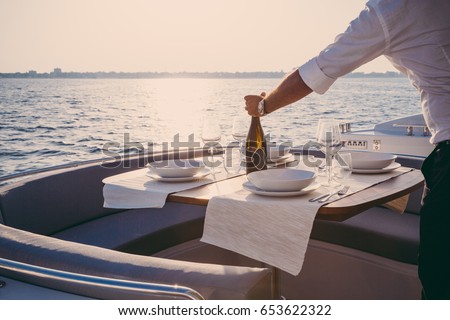romantic lunch on motor yacht at sunset, Table setting at a luxury yacht.