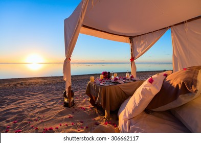 Romantic Luxury Dinner Setting At Tropical Beach On Sunset