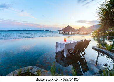 Romantic Luxury Dinner Setting At Tropical Resort On Sunset