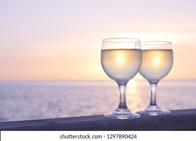 Romantic Luxury Evening On Cruise Yacht With Winery Setting. Glasses, White Wine And Tropical Sunset With Sea Background. Vacation Relax Time On The Sea Of Maldives Island.