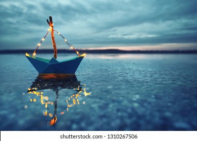 romantic magic winter evening at the lake with blue boat - Powered by Shutterstock