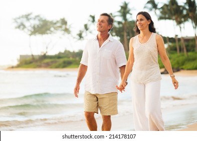 Romantic Mature Couple Enjoying Walk On The Beach