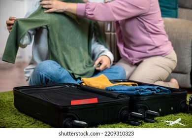 Romantic Mature Retired Packing Clothes Travel Bag Suitcase Together On Floor At Home For Holiday, Asian Couple Old Senior Married Retired Smiling Prepare Luggage Suitcase Arranging For Travel