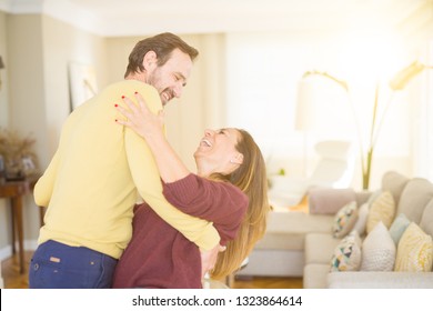 Romantic Middle Age Couple Dancing Together In Love At Home