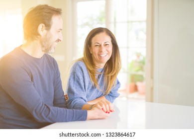 Romantic middle age couple sitting together at home - Shutterstock ID 1323864617