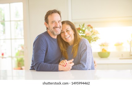 Romantic Middle Age Couple Sitting Together At Home