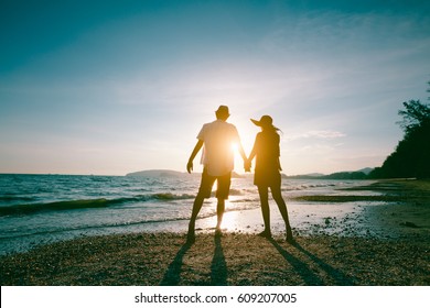 Romantic middle aged couple enjoying beautiful sunset walk on the beach travel vacation, Krabi Thailand - Powered by Shutterstock