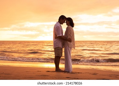 Romantic Middle Aged Couple in Love Embracing on the Beach at Sunset - Powered by Shutterstock