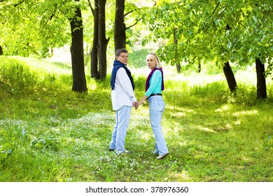 Romantic Middle Aged Couple Walking In Countryside And Holding Hands